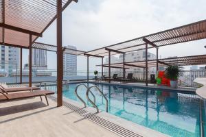 a swimming pool on the roof of a building at Monalisa Apartment in Danang