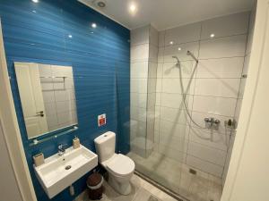 a bathroom with a shower and a toilet and a sink at VIAL Rooms in Himare