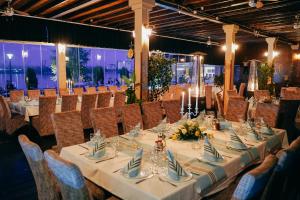 a dining room with a long table and chairs at Hotel Djerdap in Kladovo