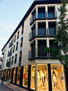 a building with a lot of windows on a street at Aiguaneu El Celler in Blanes