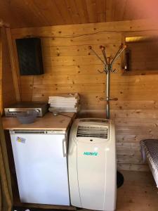 a kitchen with a refrigerator and a stove in a cabin at Sillaotsa camp in Paide