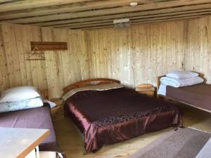 a bedroom with two beds in a wooden cabin at Sillaotsa camp in Paide