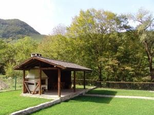 a gazebo in a park with trees and a fence at Boyana Vacation Houses in Cherni Vit