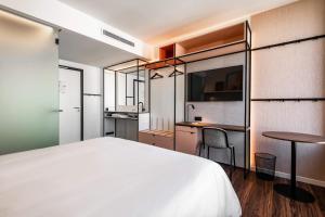 a bedroom with a white bed and a table at A-STAY Antwerp in Antwerp