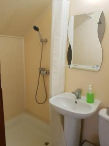 a bathroom with a sink and a shower with a mirror at Барокко in Bilhorod-Dnistrovskyi