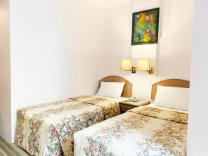 Postel nebo postele na pokoji v ubytování Hotel Rainbow