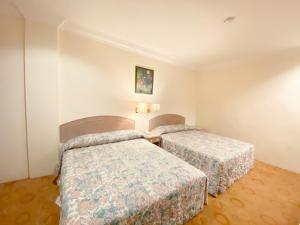 Postel nebo postele na pokoji v ubytování Hotel Rainbow