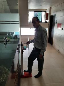 a man standing next to a counter in a kitchen at Hotel Good Night in Ahmedabad