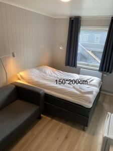 a small bed in a room with a window at Mosjøen Overnatting, Finnskoggata 20 in Mosjøen