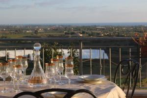 un tavolo con bicchieri da vino in cima a un balcone di Belvedere Sasso a Sasso
