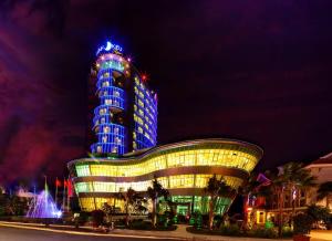 a building with blue lights on it at night at Ninh Kieu Riverside Hotel in Can Tho