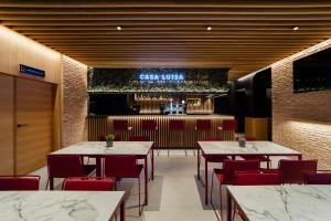 a restaurant with tables and chairs and a bar at HOTEL RESTAURANTE CASA LUISA in Estella
