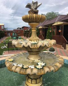 a fountain with a bird sitting on top of it at Hotel Almaz in Akhtubinsk