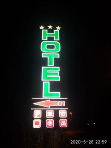 a neon sign for a hotel with stars on it at Hotel Napoleon-Cuore in Qualiano
