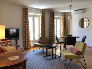 a living room with chairs and tables and a couch at LE BAIN DE SOLEIL luxury 2 bedrooms Cannes centre in Cannes