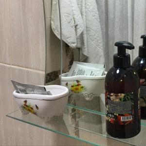 a bathroom with a toilet and a bottle of soap at Hotel Almaz in Akhtubinsk