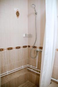 a bathroom with a shower with a shower curtain at Hotel Almaz in Akhtubinsk