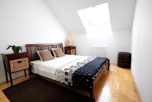 a bedroom with a large bed and a window at King Apartments in Budapest