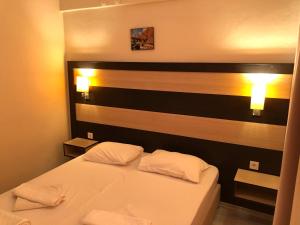 a bedroom with a bed with two white pillows at Sun Hotel in Çeşme +57 photos