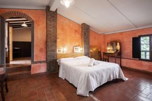 a bedroom with a bed in a room with orange walls at Fattoria Sant'Andrea - Farm Stay in San Gimignano
