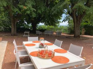 a white table with orange plates on it at La Souveraine in Saint-Genis-Laval