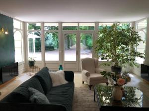 a living room with a couch and a table at La Souveraine in Saint-Genis-Laval