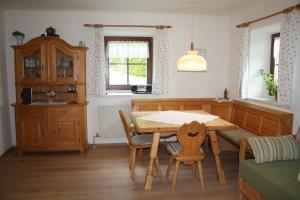 a dining room with a wooden table and chairs at Ferienhaus Julia in Admont