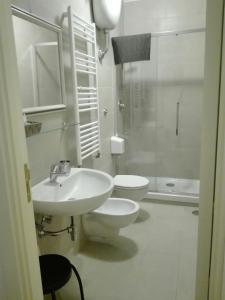a bathroom with a sink and a toilet and a shower at Napoli Pietrasanta LT in Naples