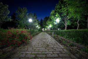 a stone path at night with street lights at Villa Il Castagno dell'Etna in Maletto
