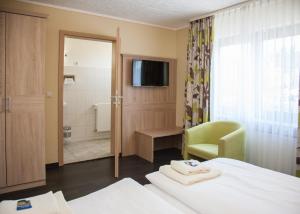 Postel nebo postele na pokoji v ubytování Hotel Sassor