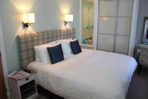 a bedroom with a large white bed with two pillows at The Marine in Thurso