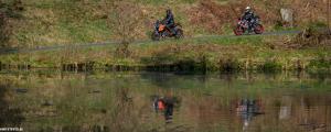 two people riding motorcycles next to a body of water at Hotel Sassor in Battenberg