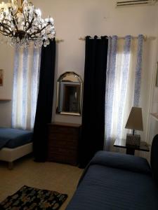 a bedroom with black curtains and a mirror and a bed at Alloggi alla Scala del Bovolo in Venice