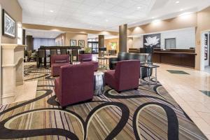 a lobby with a waiting area with purple chairs at La Quinta by Wyndham Buena Park in La Palma