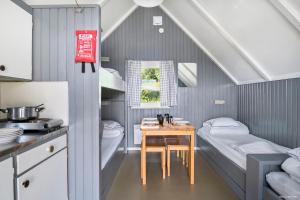 a kitchen with two beds and a table in a room at First Camp Frösön-Östersund in Frösö