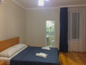 Ένα ή περισσότερα κρεβάτια σε δωμάτιο στο Guest House Maradona