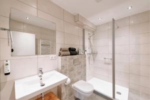 a bathroom with a toilet and a sink and a shower at Löwen Hotel & Restaurant in Marktbreit