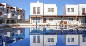 a swimming pool in front of some buildings at Casa Zen in Puerto Calero