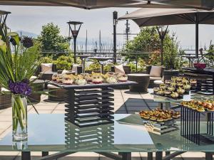 a table filled with food on top of a patio at Mövenpick Hotel Lausanne in Lausanne