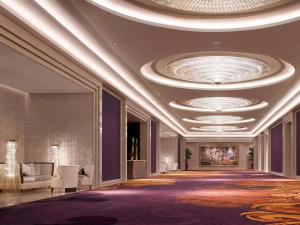 a lobby of a hotel with a large ceiling at Raffles Jakarta in Jakarta