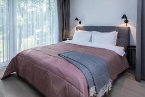 Postel nebo postele na pokoji v ubytování Apartment Hotel Laisve