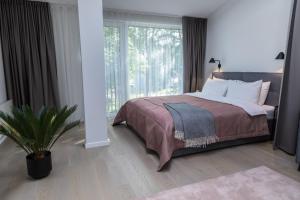 Postel nebo postele na pokoji v ubytování Apartment Hotel Laisve