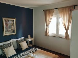 a bedroom with a bed and a window at Apartments Paklenica in Starigrad-Paklenica