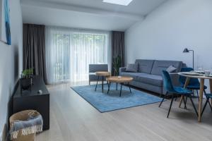 a living room with a couch and a table at Apartment Hotel Laisve in Druskininkai