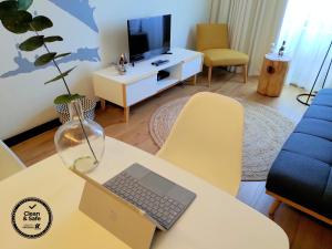 a living room with a table with a laptop on it at PicPorto Apartment in Porto