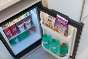 an open refrigerator filled with food and drinks at Lux Caracciolo in Naples
