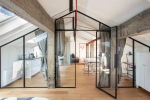 a room with glass doors and a dining room at Mato Apartment Torino in Turin