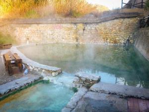 a hot spring in a stone wall with a hot tub at Carpe Diem in Lamezia Terme