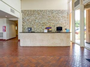 a lobby with a reception counter in a building at OYO Hotel Killeen East Central in Killeen