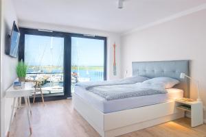 Ein Bett oder Betten in einem Zimmer der Unterkunft Yachtenkieker